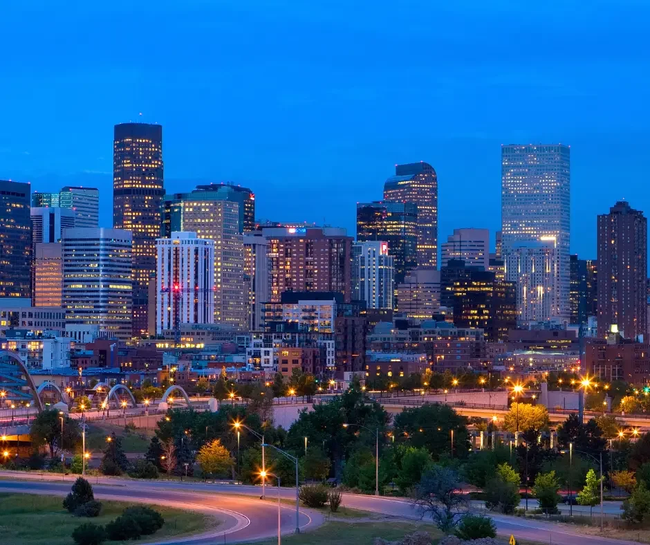 A scenic photograph of the downtown Denver, Colorado skyline during the blue hour after sunset.